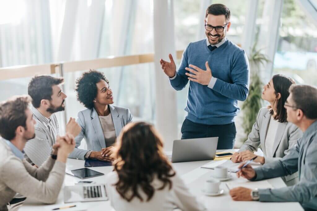 happy manager leads a meeting in the office scaled 1