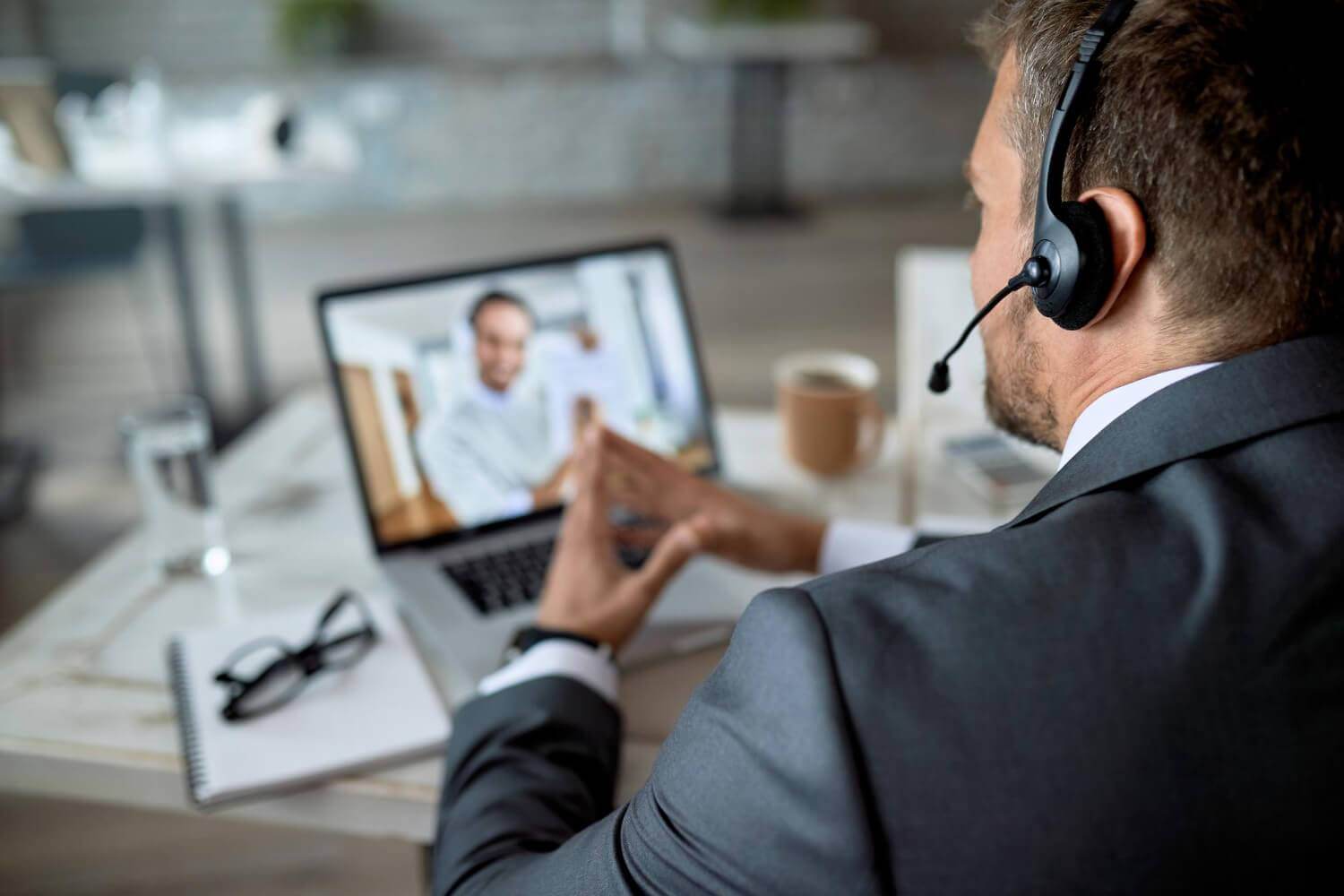 closeup entrepreneur using laptop while having online business meeting office